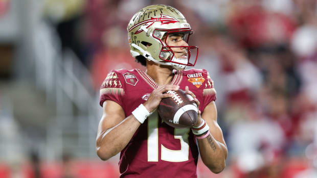 Florida State Seminoles quarterback Jordan Travis (13) drops back to pass against the Oklahoma Sooners in the second quarter during the 2022 Cheez-It Bowl at Camping World Stadium.